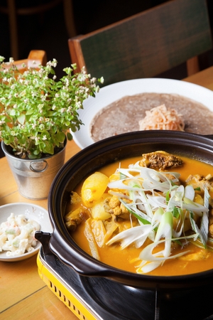 Curry braised chicken with onions and seasoned green onions, in potの写真素材