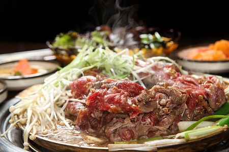 Marinated bulgogi with various vegetables such as welsh onions and mushrooms, in potの写真素材