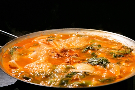 Beef tripe hot pot with various vegetables such as welsh onions and onions, in potの写真素材