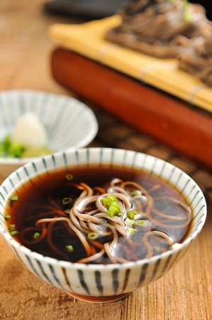 Buckwheat noodles in soy sauce, in bowlの写真素材