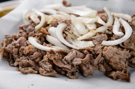 Marinated bulgogi with onions on plateの写真素材
