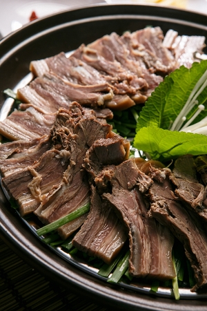 Boiled pork and perilla leaf and mushrooms, in china bowlの写真素材