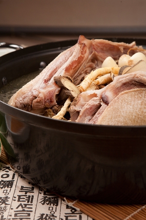 Boiled duck with scorched rice, with jujube, ginseng and whole garlic, in potの写真素材