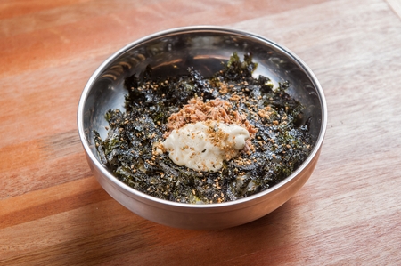 Rice balls with dried seaweed and egg on grey plateの写真素材