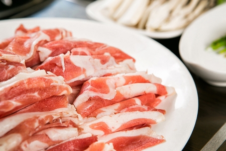 Raw duck meat on white plateの写真素材