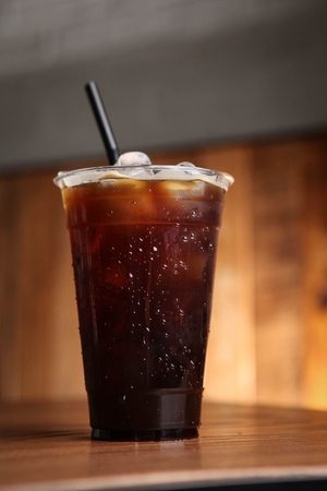 Iced americano with straw, in glassの写真素材