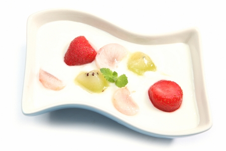 Basic yoghurt with strawberry and kiwi, in white bowlの写真素材