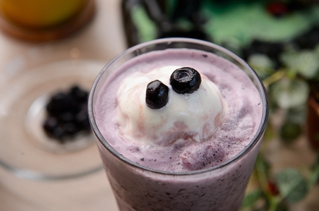 Blueberry smoothie with ice cream, in glass