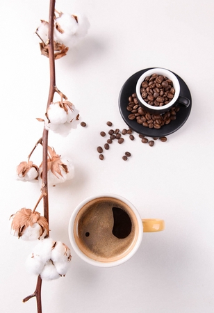 Hot americano in mug cup and coffee beans in cupの写真素材