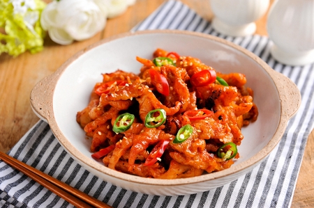Spicy boneless chicken feet with chili on china plate