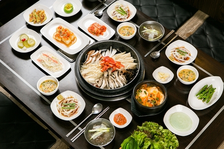 Bulgogi with mushrooms on plate, with side dishesの写真素材