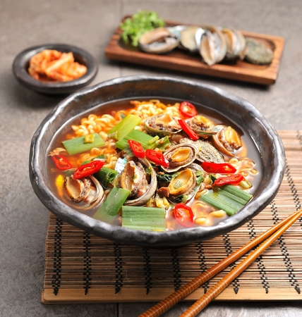 Abalones ramen with vegetables in china bowl, with chopsticksの写真素材