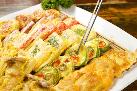 Assortment Korean pancakes served on plate with chopsticksの写真素材