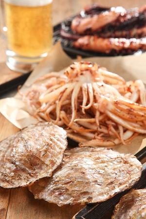 Grilled Dried Filefish Fillet served on porcelain plate with beerの写真素材