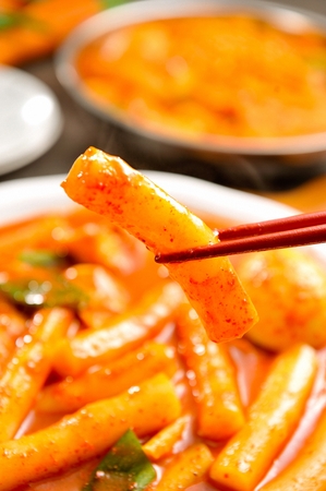 Spice Rice Cake with spring onions served in bowl with chopsticksの写真素材