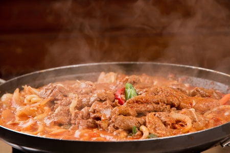 Red pepper paste bulgogi with chili, being grilled on panの写真素材