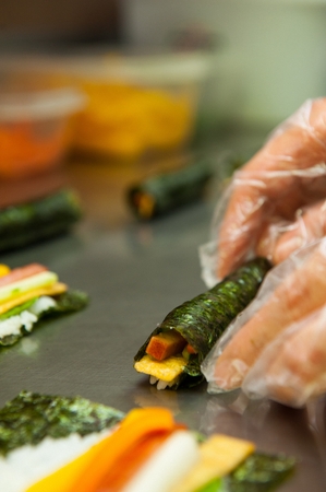 Chef's Hand making mini Korean sushi rollの写真素材