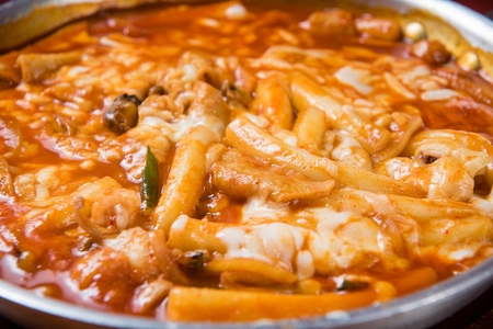 Spicy Rice Cake with Cheese on panの写真素材
