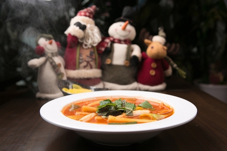 Spicy Rice Cake with Spring Onion and perilla leaves in bowl