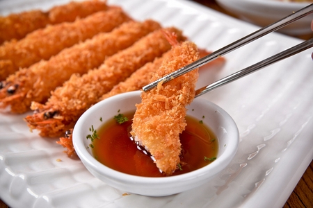 Fried Shrimp with Sauce and Chopsticks served on plateの写真素材