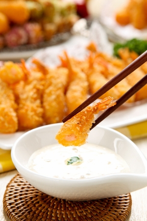 Fried Shrimp with sauce and chopsticks served on plateの写真素材