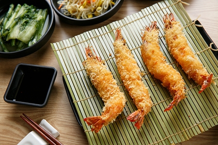 Fried Shrimp with Sauce and Chopsticks served on bamboo shootsの写真素材