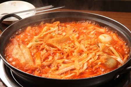 Spicy Rice Cake with Cabbage and fried vegetables served on panの写真素材