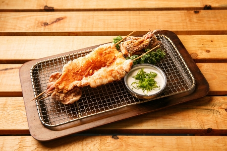 Fried squid with sauce served on plateの写真素材