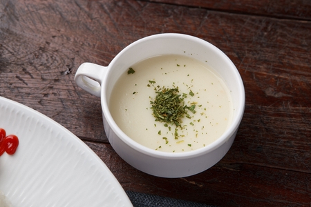 Soup with Pasley Powder sprinkled on top served in bowlの写真素材