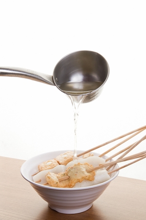 Fish Kebab and Konjac (special Asian plant) Kebab inside fish cake soup served in bowlの写真素材
