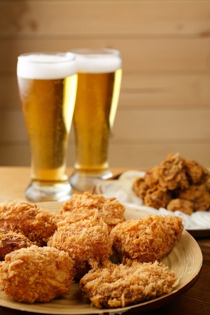 Croquette served on wooden plate with beerの写真素材