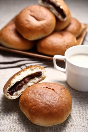 Red Bean Bun served on wooden table with milkの写真素材