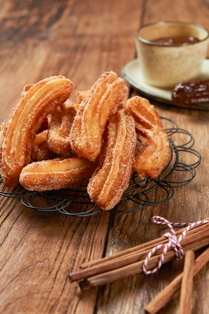 Churros with sprinkled sugar on top  served on plateの写真素材