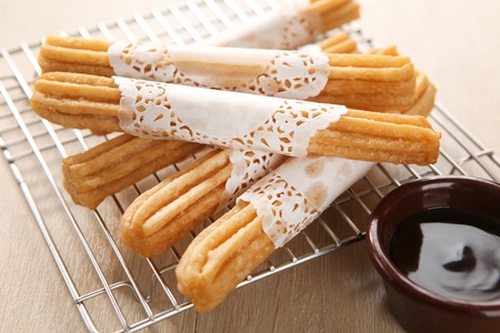 Churros and Jam packaged in wrapping paper on frying plate