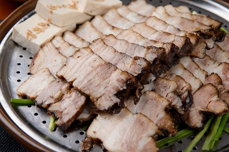 boiled pork on plate filled with chives