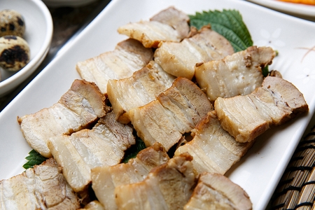 Korean cuisine Suyuk, boiled pork slices on plateの写真素材