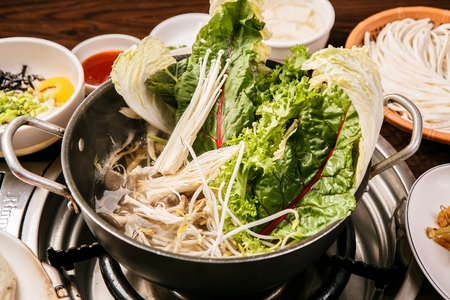 Shabu-shabu restaurant setting, hot pot with vegetablesの写真素材