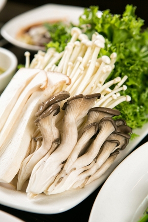 Shabu-shabu vegetables like mushroom, bok choy on plateの写真素材