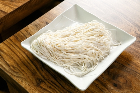 uncooked noodles on white plate