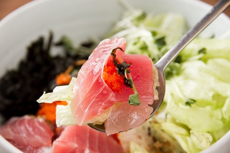 Korean cuisine Hoe-deopbap, spicy raw fish Bibimbap mixed rice with vegetables on spoonの写真素材