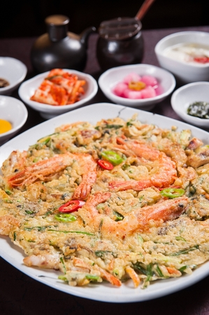 Korean seafood pancake Jeon served with side dishの写真素材