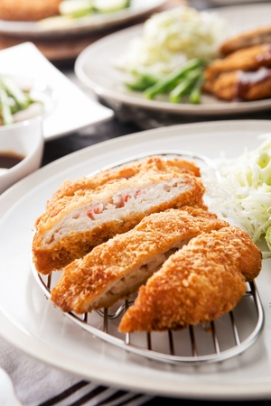 Donkatsu, pork cutlet with sauce served with lettuce saladの写真素材