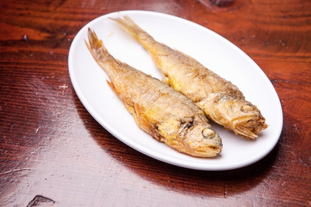 grilled croaker fish on plate