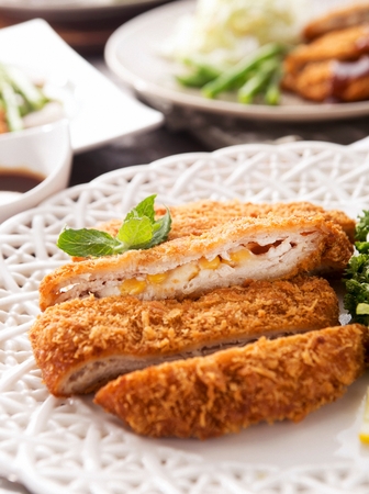 Donkatsu, pork cutlet with sauce served with lettuce saladの写真素材