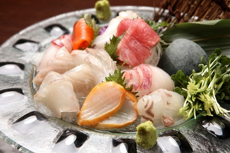 assorted sashimi platter on transparent plate including salmon and flatfish sashimiの写真素材