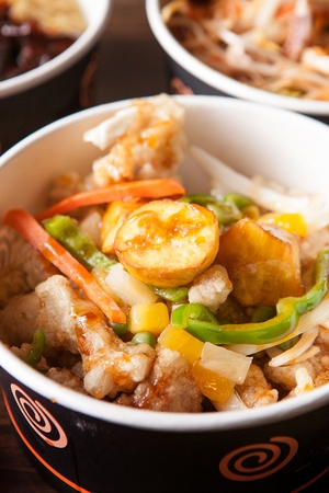 Tangsuyuk, Korean style sweet and sour pork with vegetables in disposable plateの写真素材