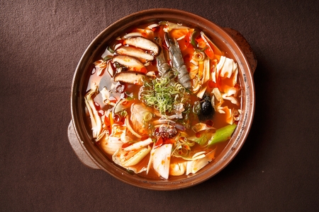 Korean-Chinese cuisine, Jjambbong, spicy seafood noodle soup with vegetables in Ttukbaegi, earthen potの写真素材