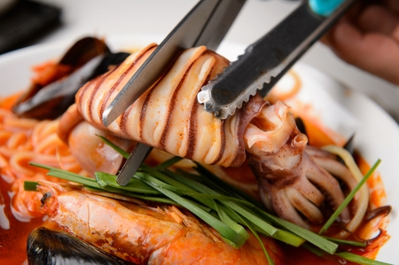 Korean-Chinese cuisine, Jjambbong, spicy seafood noodle soup with squid, mussel and shrimpの写真素材