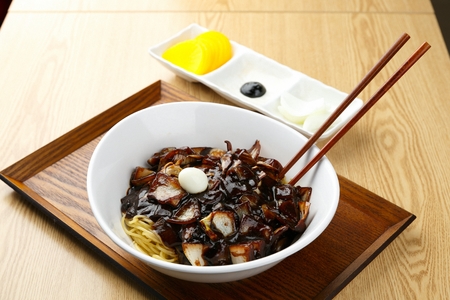 Korean-Chinese cuisine, Jjajangmyeon, black bean noodles with quil eggs served with pickled radish and onionの写真素材