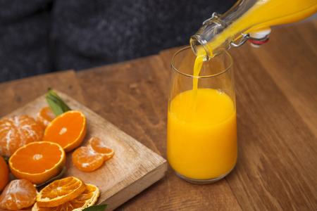 Collections of fresh tangerines. Tangerine slices, juice with leaves. Fruit composition.の写真素材